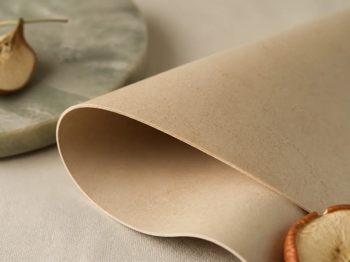 Close-up of apple leather swatch showing soft matte surface and fine grain